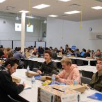 project day attendees in a the event space with tables